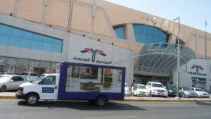 OUTDOOR CAR Wrap Advertisements Abu Dhabi | Coordinate Advertising And Marketing Vehicle branding cars attached on trailer